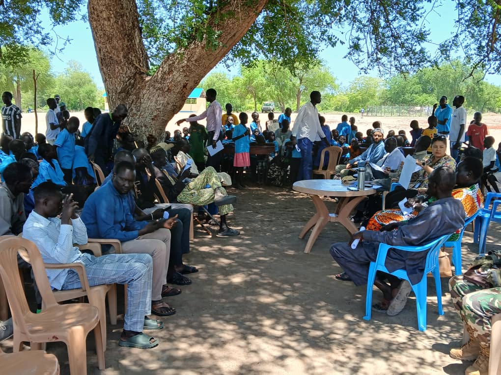 RASI team conducting community meeting and training session